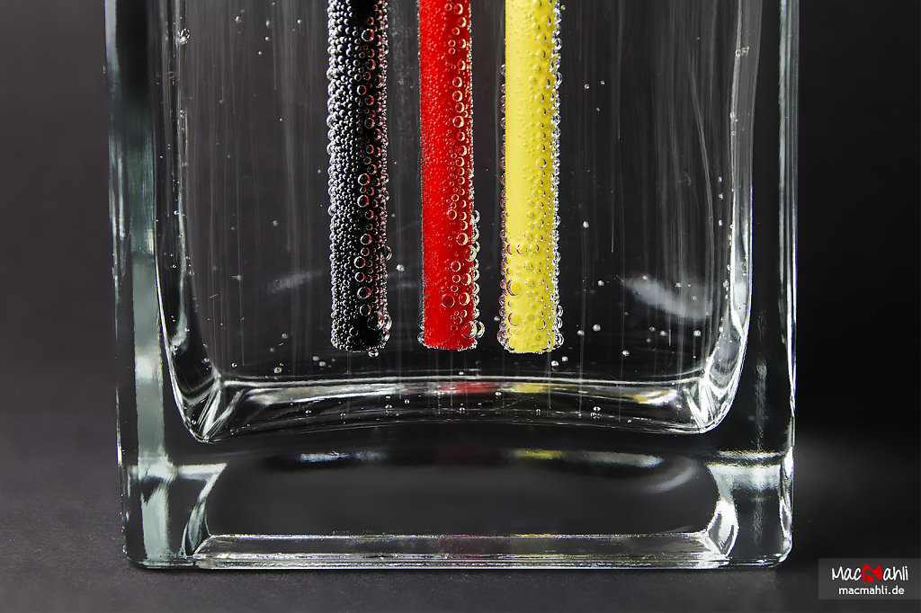 Water beads at straws in Germany colors.